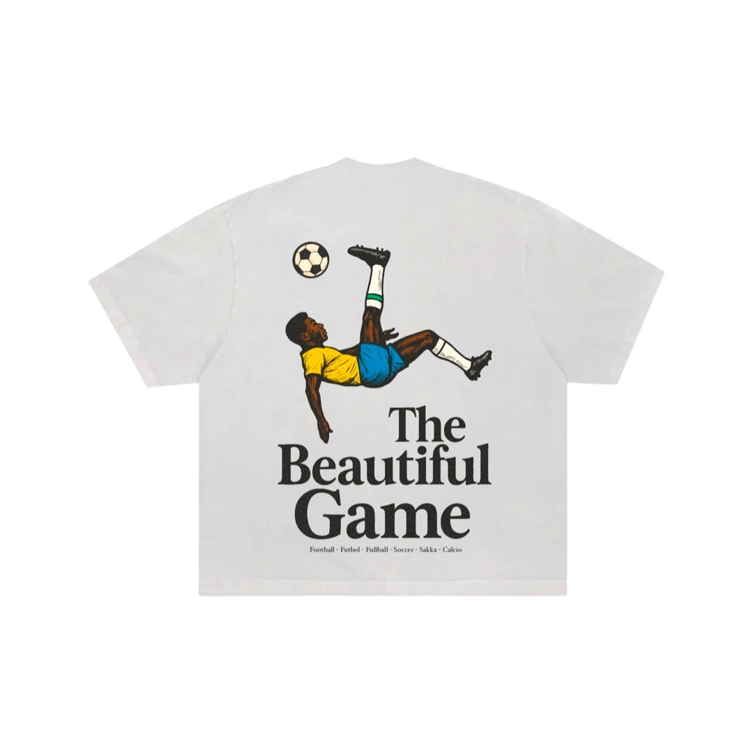 White t-shirt with soccer graphic and 'The Beautiful Game' text on a white background